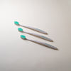 Three FRSHN UP OG Toothbrushes with bristles on a white surface.