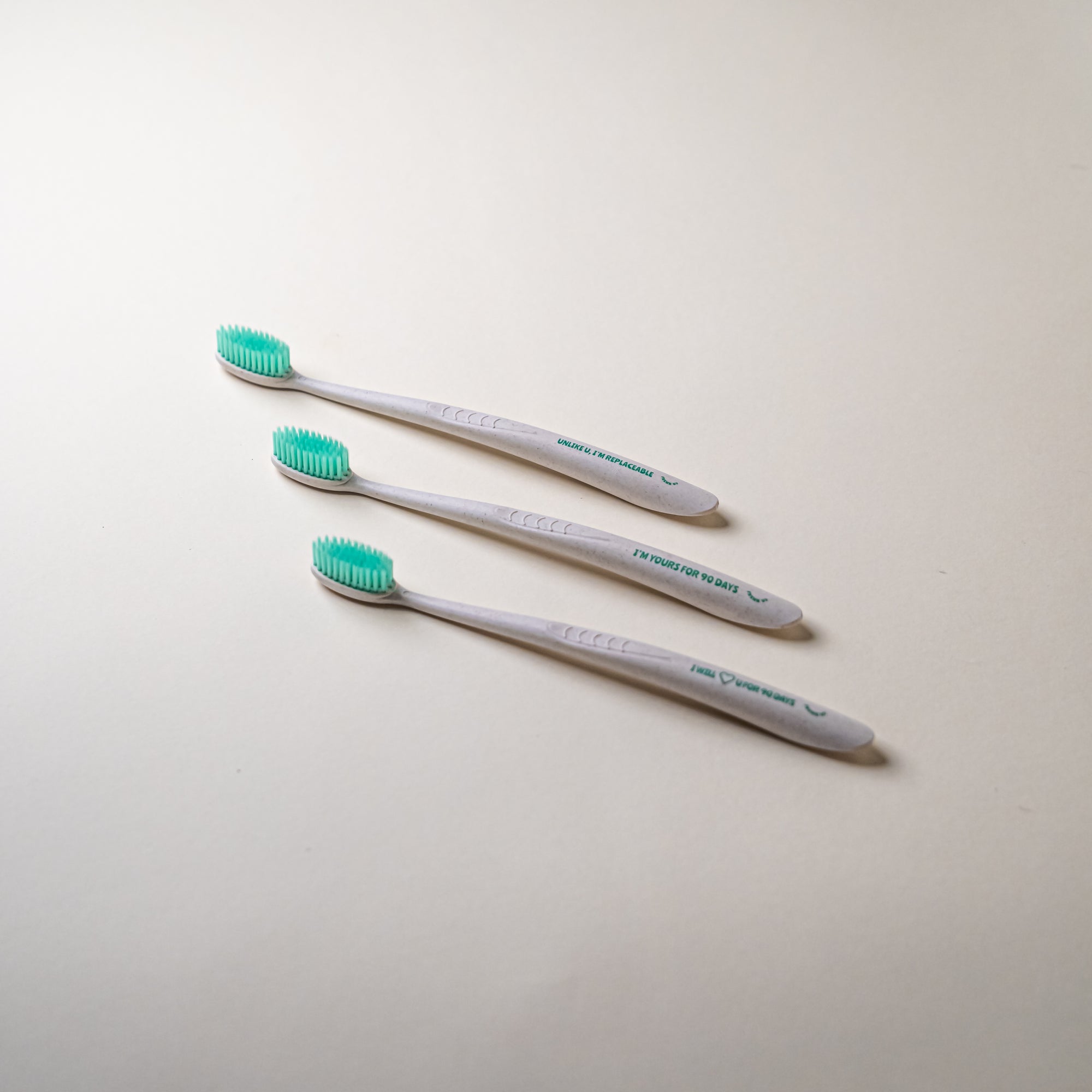Three FRSHN UP OG Toothbrushes with bristles on a white surface.